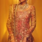 Red and gold pakisatni traditional lehnga by pakisatni fashion designer Tena Durrani