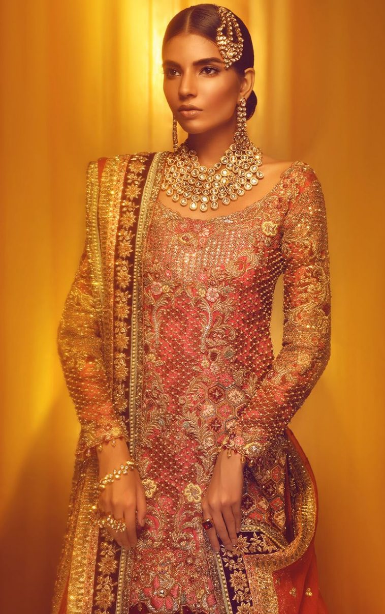 Red and gold pakisatni traditional lehnga by pakisatni fashion designer Tena Durrani